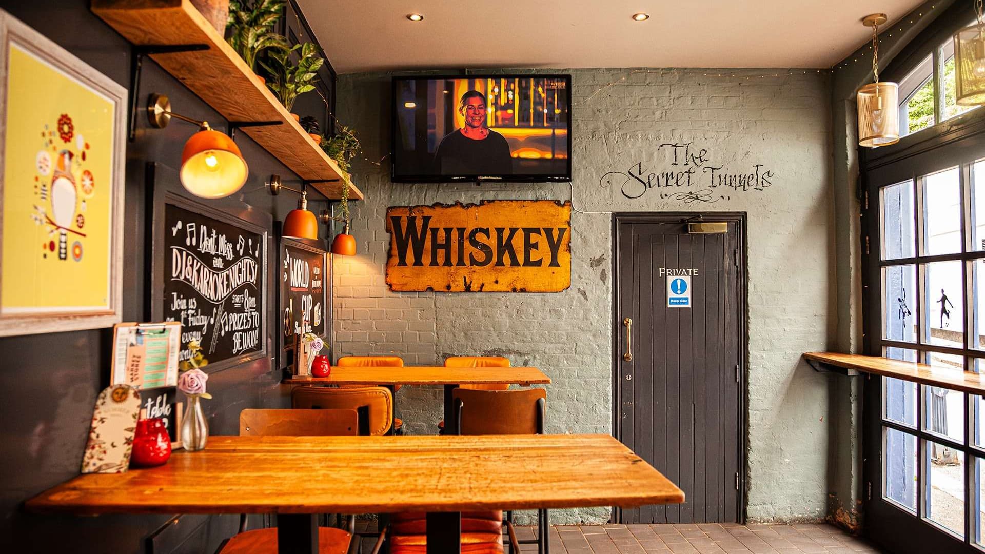Seating area with whiskey sign at Market Stores Reigate